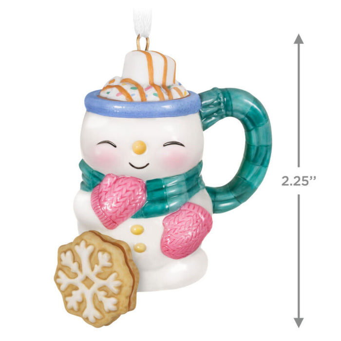 Decorative snowman mug ornament with a scarf and a cookie on a white background with product dimensions 