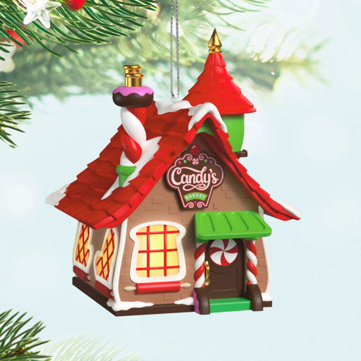 Christmas ornament Bakery with candy decorations on it,  hanging on a tree branch.