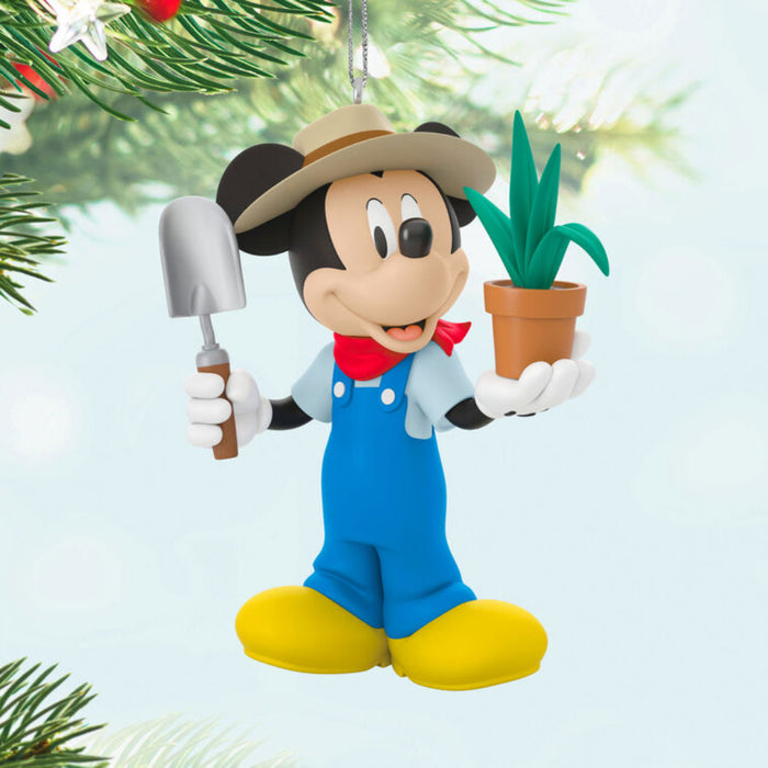 Mickey Mouse in a gardener outfit holding a potted plant and a shovel Ornament hanging on a tree 