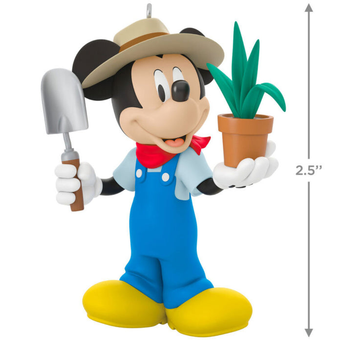 Mickey Mouse  in a gardener outfit holding a potted plant and a shovel Ornament on a white background with product dimensions 