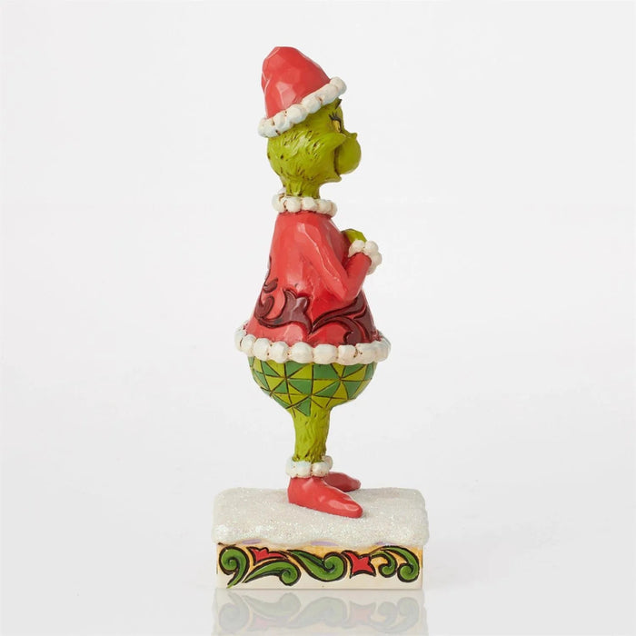 Colorful figurine of a character with a red hat and green body on a white background