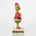 Colorful figurine of a character with a red hat and green body on a white background