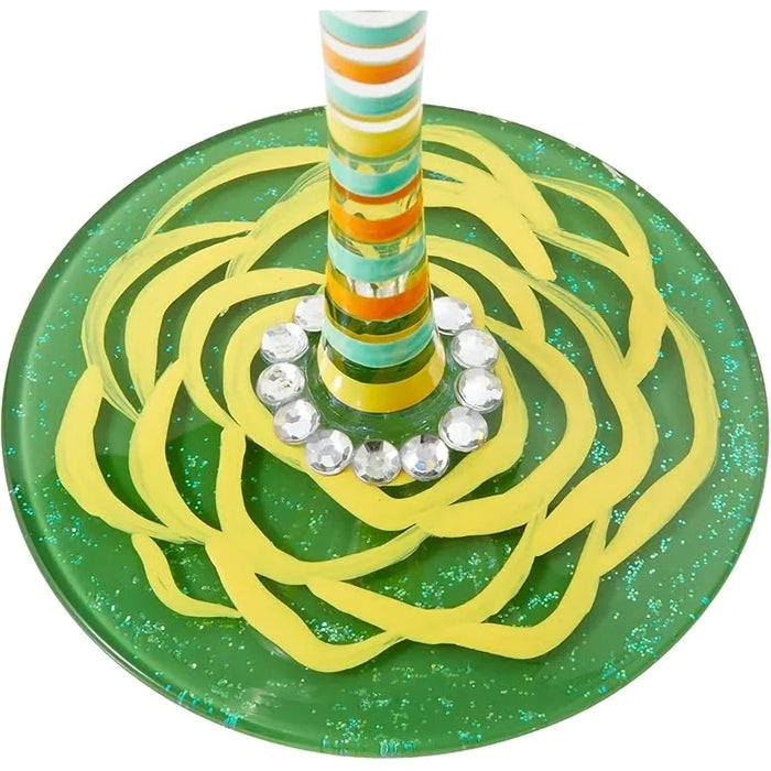Green and yellow swirled wine glass base with a striped stem on a white background