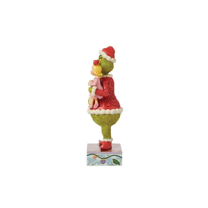 Right side view Jim Shore Figurine of Grinch in a red sweater and Santa hat holding Cindy with a sign, on a white background.