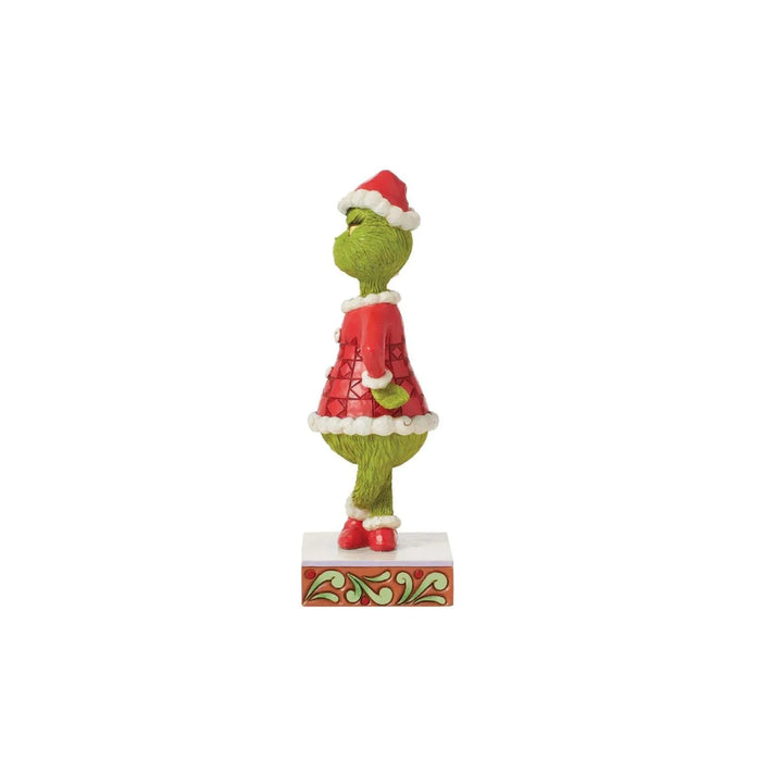 Right side view of Jim Shore Grinch figurine in red patchwork Santa suit, showing detailed hand-painted design on stage. on a white background "