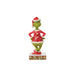 "Front view of Jim Shore Grinch figurine in red patchwork Santa suit, standing on stage with hands on hips and frowning."