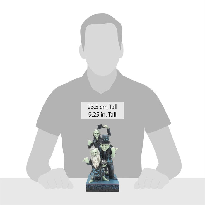 Gray silhouette of a person holding a  Jim Shore  haunted mansion hitchhiker figurine figurine with height measurements displayed on a white background 