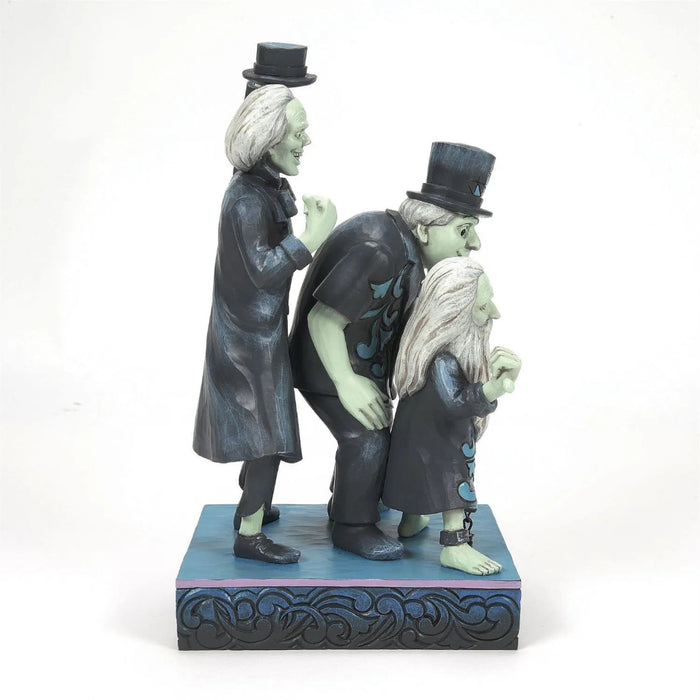 Left side view of Disney Traditions Hitchhiking Ghosts collectible figurine  by Jim Shore, featuring Phineas, Ezra, and Gus on a white background 