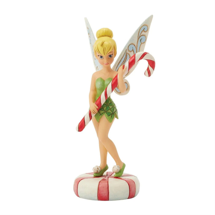 Jim Shore Figurine of Tinkerbell the fairy holding a candy cane on a white background