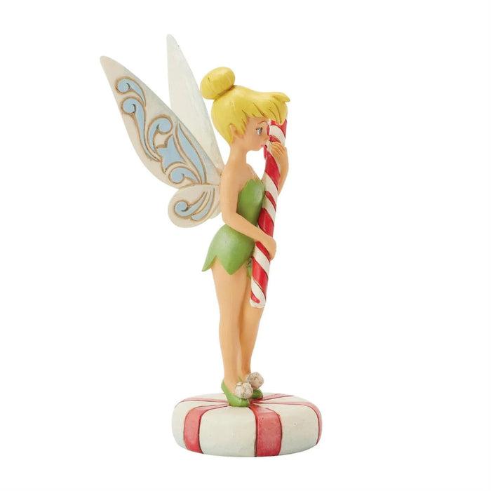  Left side view Jim Shore Figurine of Tinkerbell the fairy holding a candy cane on a white background