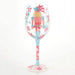 Decorative  Christmas themed wine glass with a colorful design on a white background