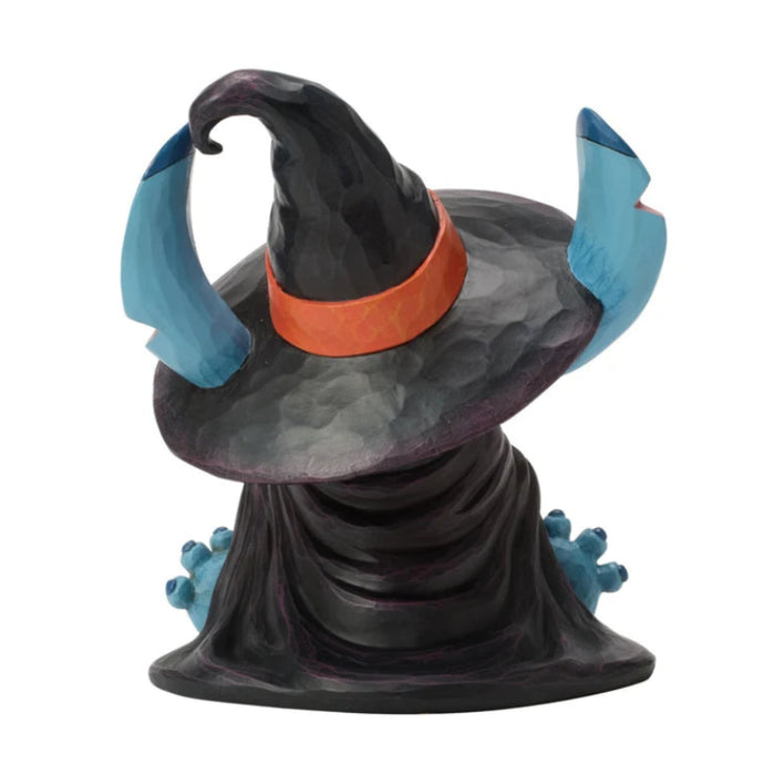 Stitch dressed as a witch standing beside a jack-o-lantern in a playful Halloween figurine.