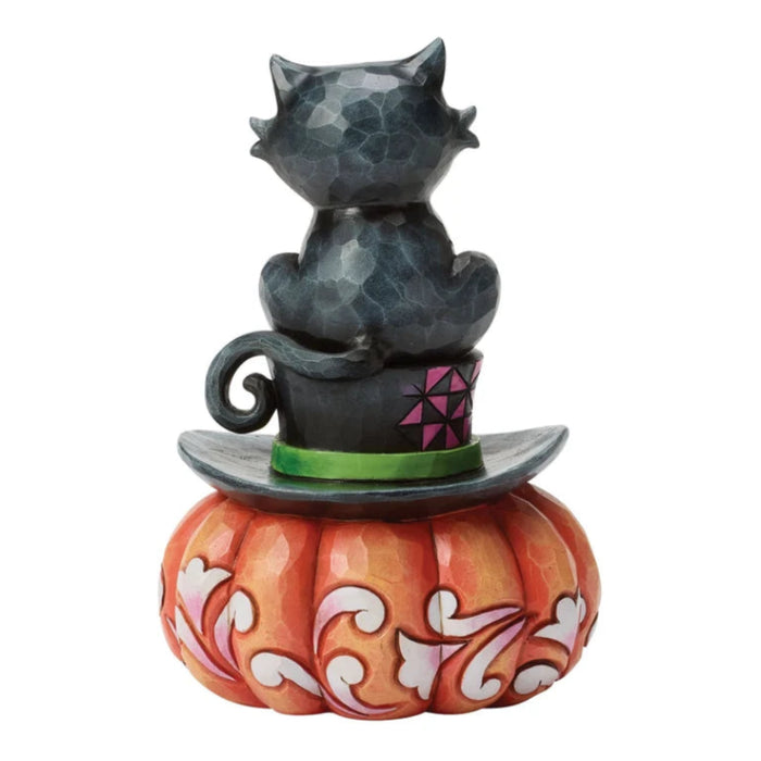 Black cat perched on a classic top hat in a whimsical Halloween figurine designed for spooky seasonal décor.
