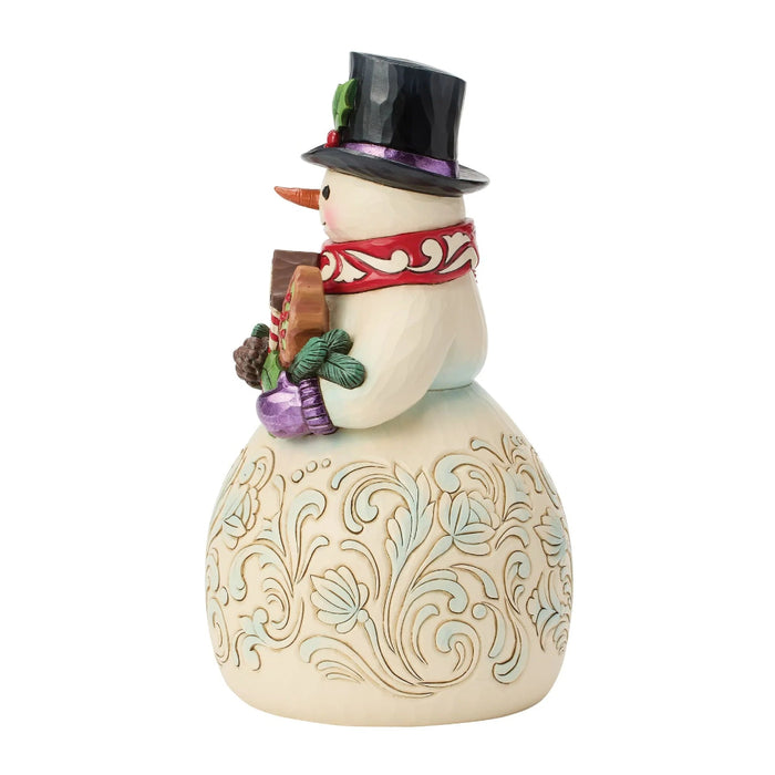 This Jim Shore Snowman with Gingerbread Cookies Figurine brings a sweet and cheerful touch to your Christmas décor.