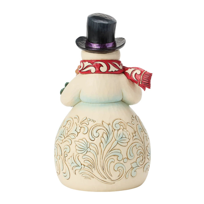 This Jim Shore Snowman with Gingerbread Cookies Figurine brings a sweet and cheerful touch to your Christmas décor.
