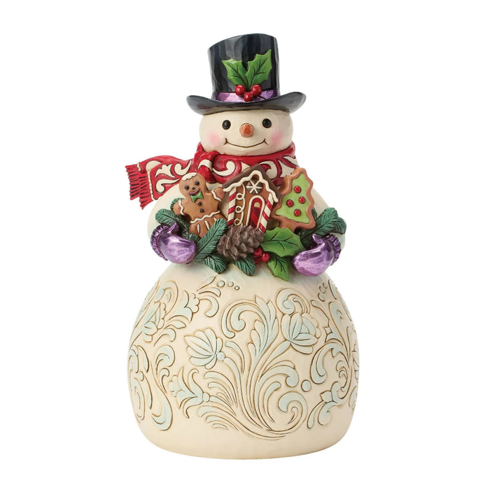 This Jim Shore Snowman with Gingerbread Cookies Figurine brings a sweet and cheerful touch to your Christmas décor.