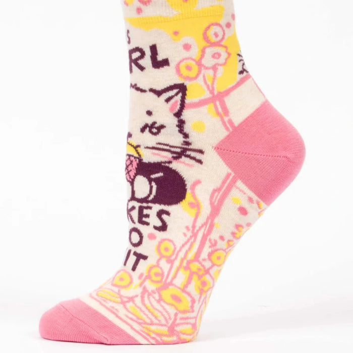 Colorful sock with cat design and text on a white background