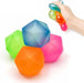 Colorful geometric stress balls on a white background