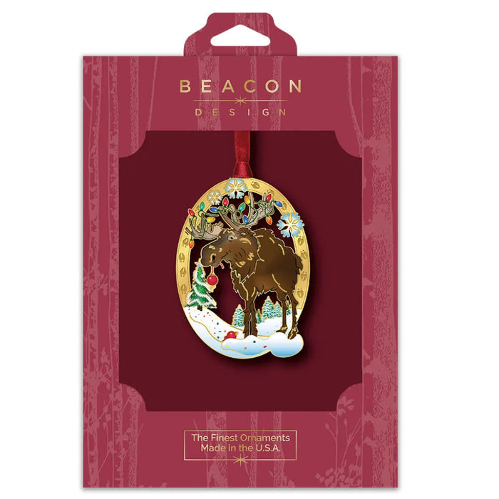 Beacon Design Christmas ornament packaging with a gold reindeer design on a red background.