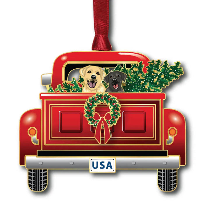 Decorative Christmas ornament of a red truck with two dogs and a wreath, featuring a USA license plate.