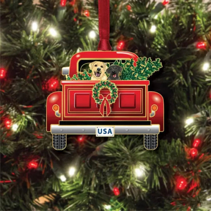 Christmas ornament of a red truck with dogs and wreath on a tree