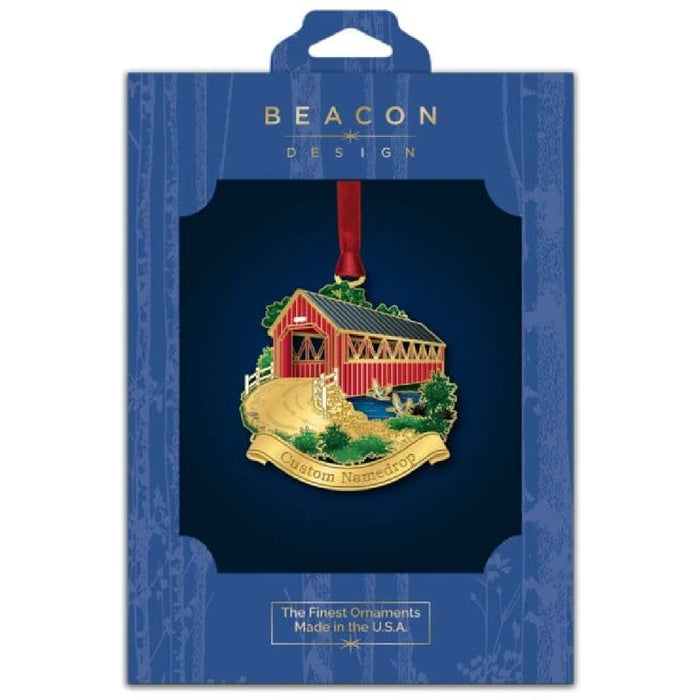 A festive red and white ornament displaying a bridge design and a sign that says "custom name" for holiday personalization.