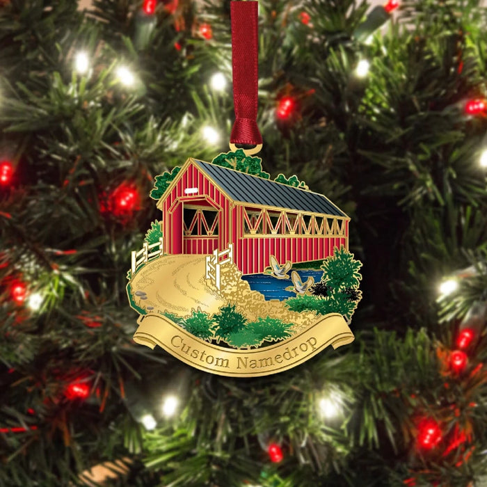 A red and white Christmas ornament with a bridge illustration and a customizable sign that reads "custom name."