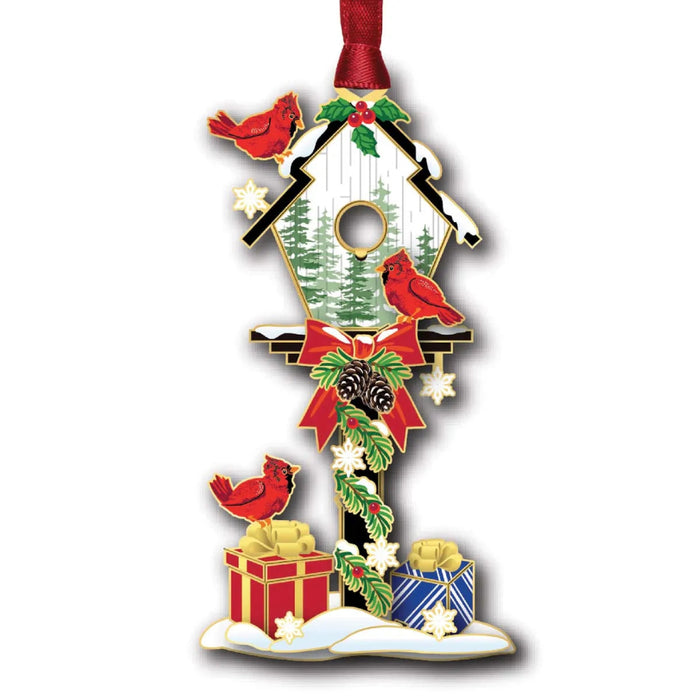Decorative Christmas ornament with a birdhouse, red cardinals, and holiday elements on a white background.