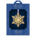 Gold snowflake ornament in Beacon Design packaging on a white background