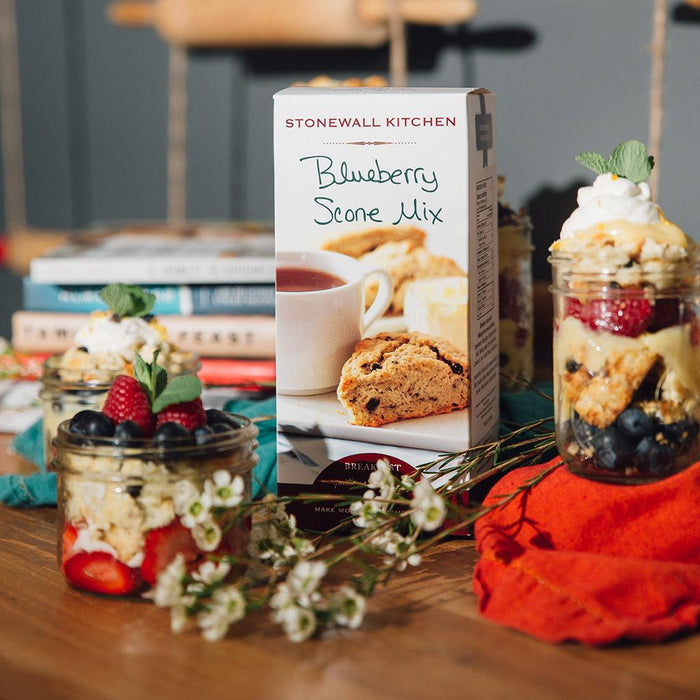 "Blueberry scone mix box with layered berry parfaits in glass jars and fresh flowers"