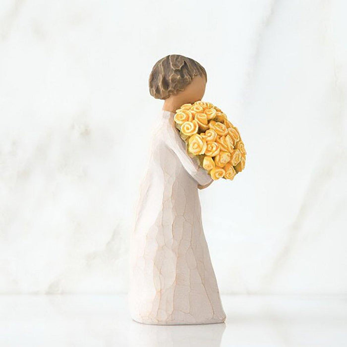"Willow Tree Good Cheer Figurine – woman holding bouquet of yellow roses, hand-carved resin sculpture by Susan Lordi symbolizing happiness and encouragement"