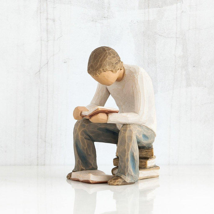 "Willow Tree Quest Figurine of boy reading book on stack of books – hand-carved resin sculpture by Susan Lordi, symbolizing learning and discovery"
