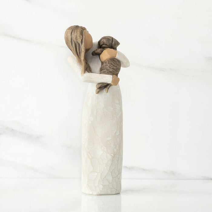 "Willow Tree Adorable You Figurine – Woman holding dark-colored dog, hand-painted resin sculpture expressing love and companionship"