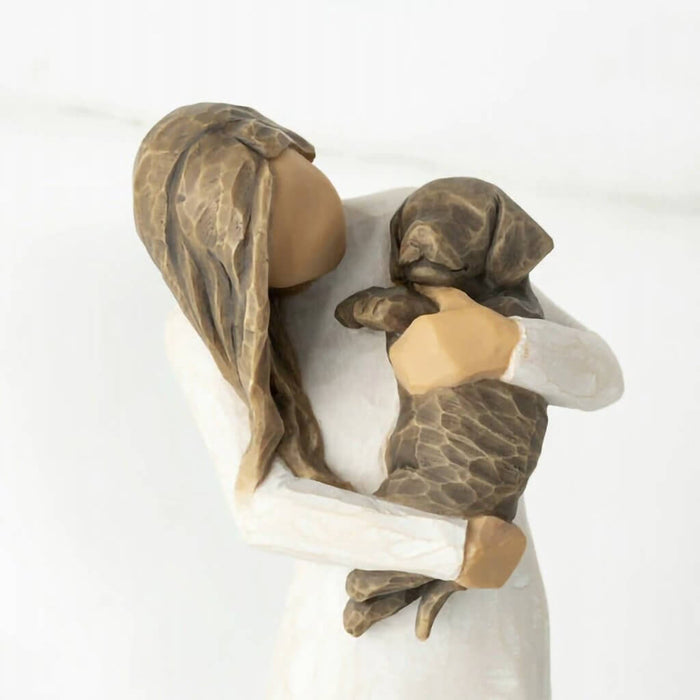 "Willow Tree Adorable You Figurine – Woman holding dark-colored dog, hand-painted resin sculpture expressing love and companionship"