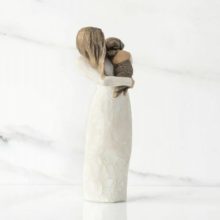"Willow Tree Adorable You Figurine – Woman holding dark-colored dog, hand-painted resin sculpture expressing love and companionship"