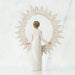 "Willow Tree Starlight Tree Topper figurine holding a starburst frame, standing atop a Christmas tree"