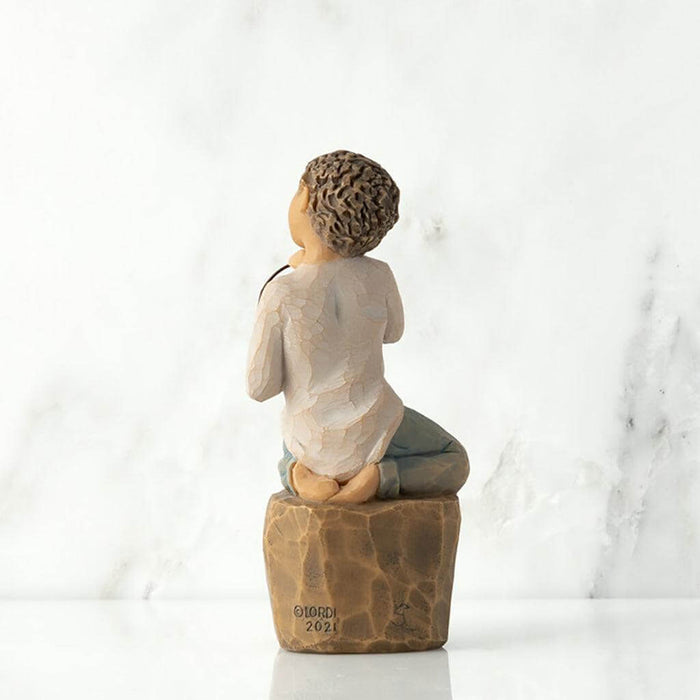 "Willow Tree Love You Too figurine – hand-painted sculpture of a boy with lighter skin kneeling and holding a wire sign that says 'love you'."