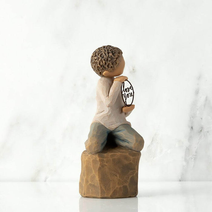 "Willow Tree Love You Too figurine – hand-painted sculpture of a boy with lighter skin kneeling and holding a wire sign that says 'love you'."