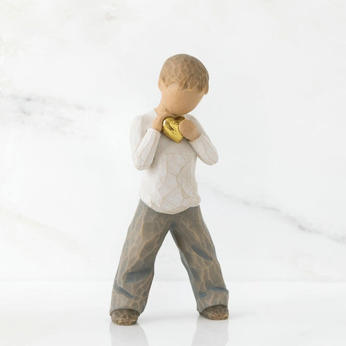 "Willow Tree Heart of Gold figurine – hand-painted resin sculpture of young boy holding a golden heart close to his chest, symbolizing love and kindness."