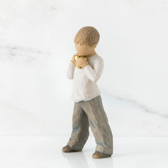 "Willow Tree Heart of Gold figurine – hand-painted resin sculpture of young boy holding a golden heart close to his chest, symbolizing love and kindness."