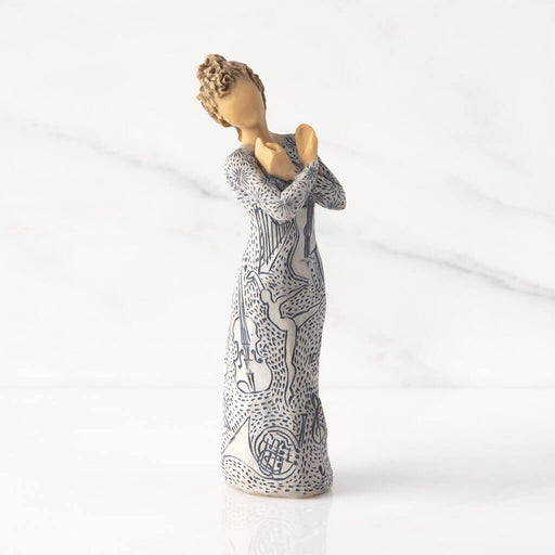 "Willow Tree Music Speaks figurine with lighter skin tone – hand-painted resin sculpture featuring musical instrument carvings and heart-holding pose"