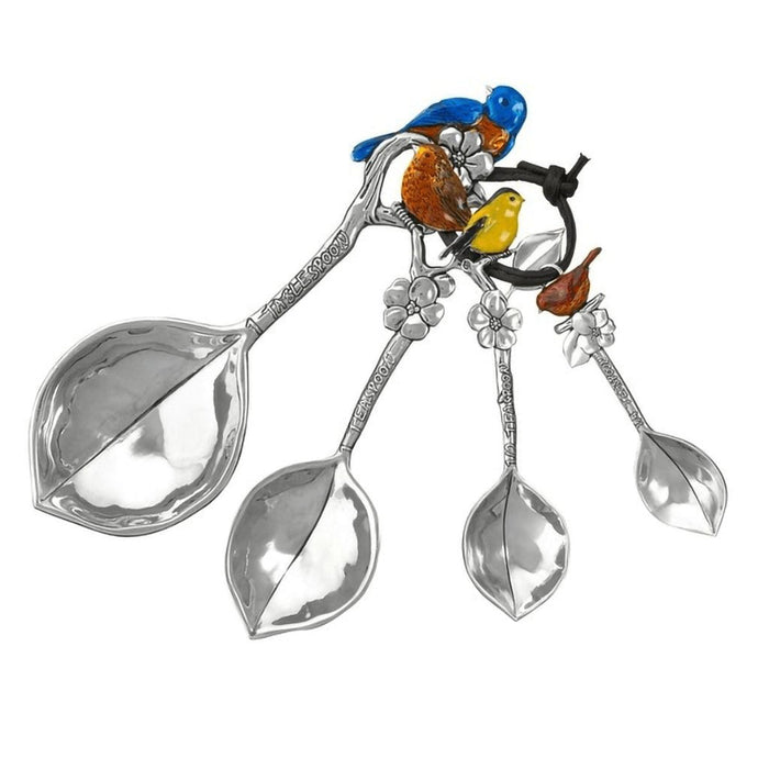 "Decorative spoon set with bird and leaf designs on a white background"
