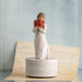 "Willow Tree Surrounded by Love musical figurine – resin sculpture of woman holding red poppies, set on rotating base that plays 'Let Me Call You Sweetheart'."