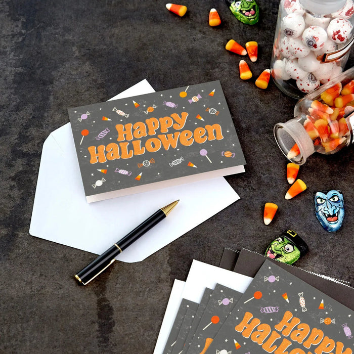 Close-up of Hallmark Halloween card with colorful candy artwork and sparkling glitter details
