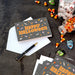 Close-up of Hallmark Halloween card with colorful candy artwork and sparkling glitter details
