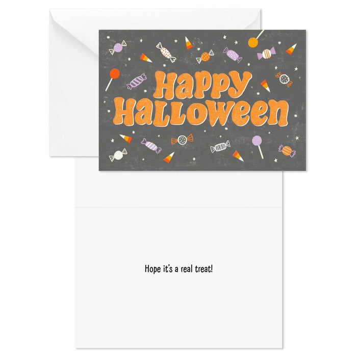 Close-up of Hallmark Halloween card with colorful candy artwork and sparkling glitter details
