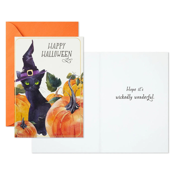 Hallmark Halloween greeting card featuring a black cat in a witch's hat surrounded by glowing jack-o'-lanterns.