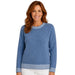 A woman wearing a heathered blue crewneck sweater with white striped trim at the collar, cuffs, and hem, paired with white pants, against a plain white background.