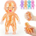 Orange glittery baby toy with additional toys and a hand holding one, on a white background