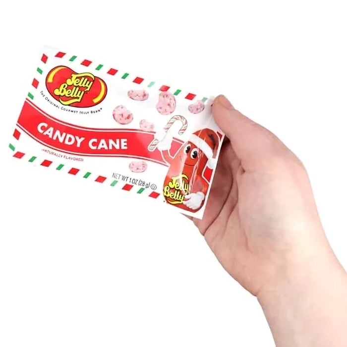 Hand holding a Jelly Belly Candy Cane jelly bean package against a white background